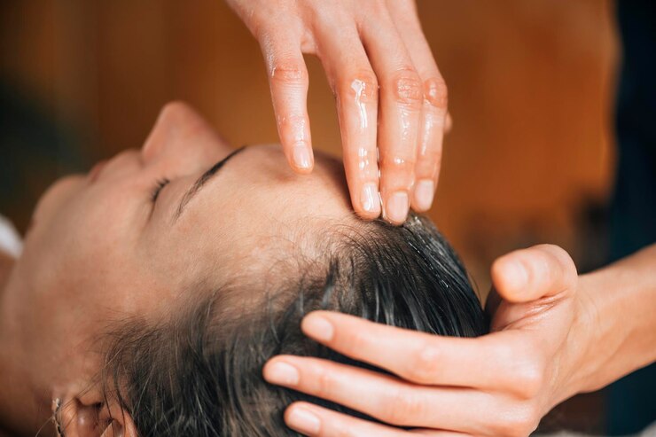 Client receiving a professional scalp massage at Häste Urban Hair Spa in Medford, MA"