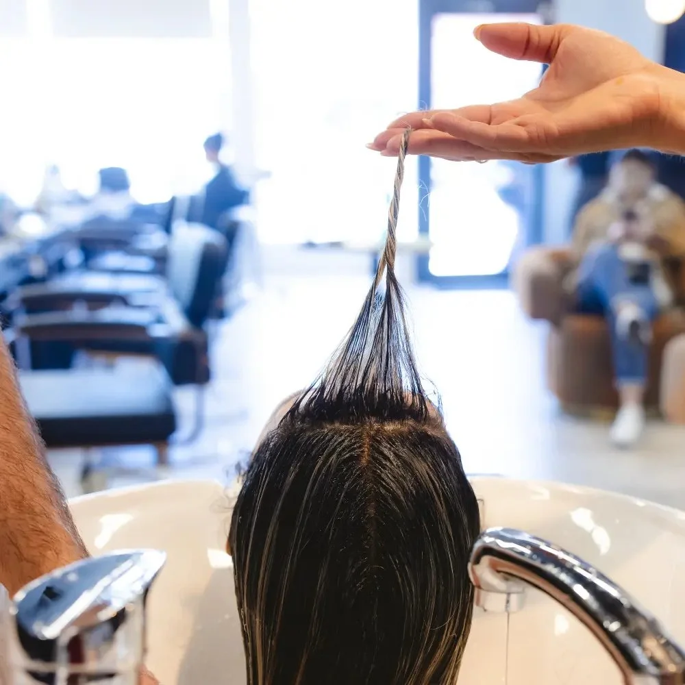 Stylist cutting hair in the Hāste Urban Hair Spa studio