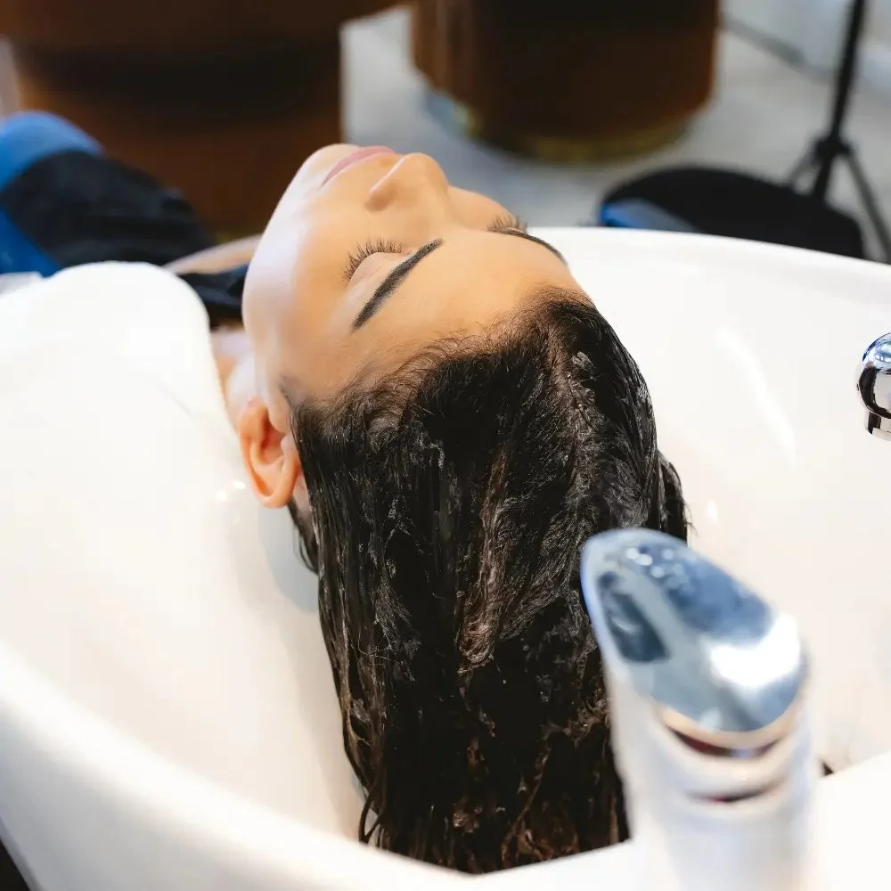 A Kérastase styling product being applied at Hāste Urban Hair Spa